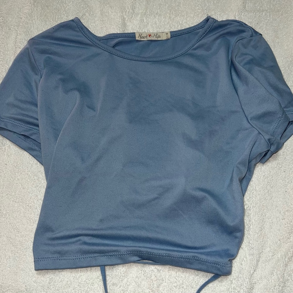 I’m selling this pretty blue crop top shirt and it’s a smooth fabric.
